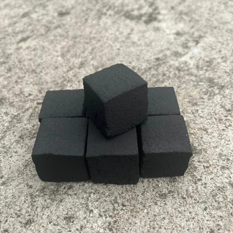 Six 26 mm coconut shell charcoal cubes showing clean pressed edges and even surface texture