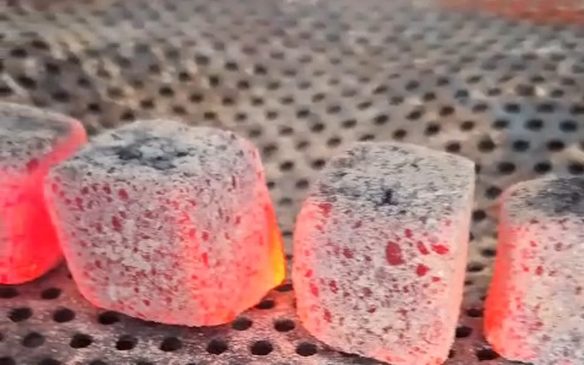 26 mm coconut charcoal cubes fully lit with an even white ash coat